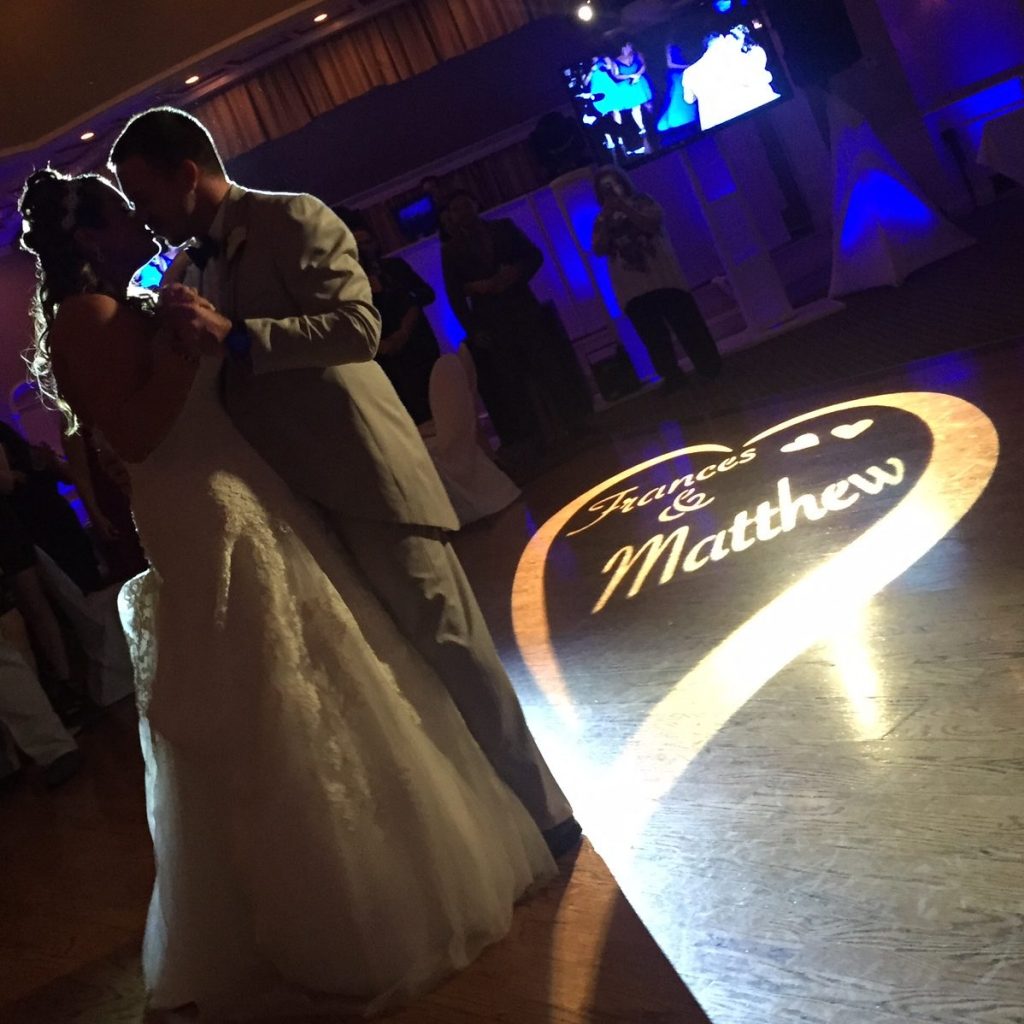 Bride and Groom dancing with custom monogram spotlight on the dancefloor