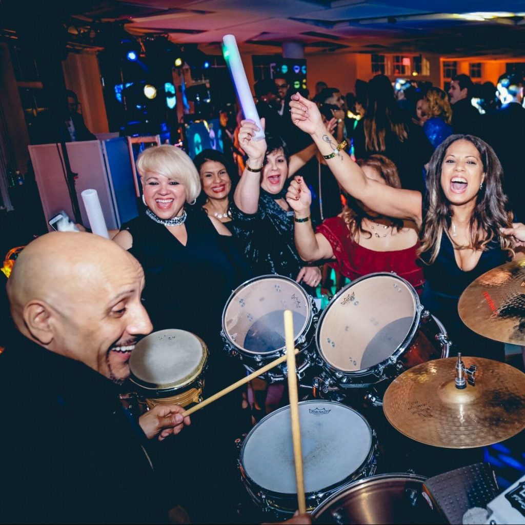 party guests dancing in front of live drummer