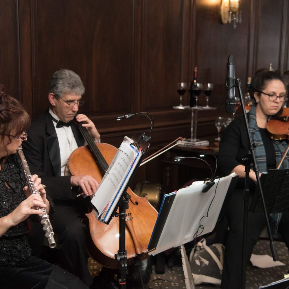 string trio performing during cocktail hour