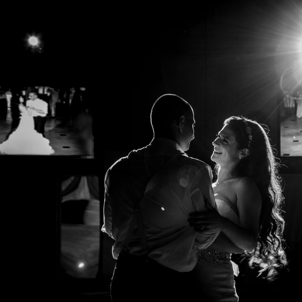 Happy couple in front of Video Displays