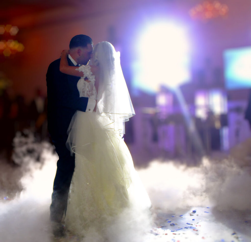 picture of bride and groom dancing on clouds